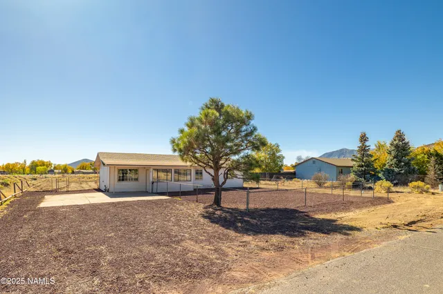 a kitchen with stainless steel appliances granite countertop wooden cabinets a stove top oven a sink and dishwasher
