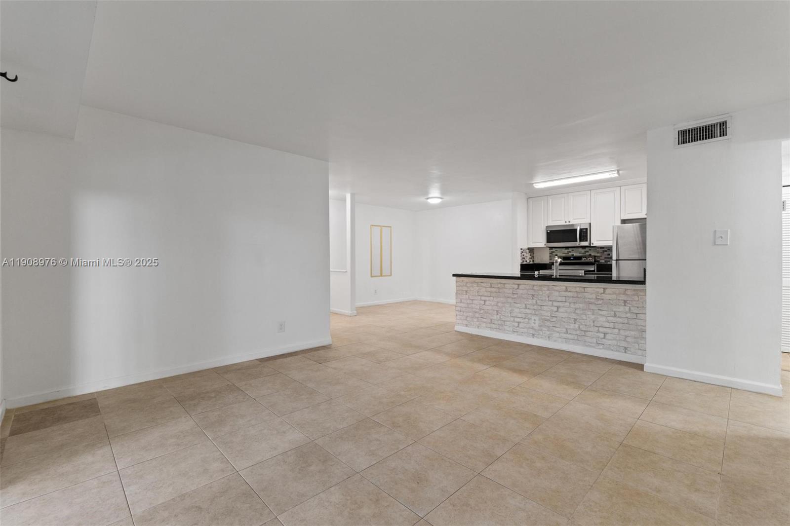 10421 Southwest 157th Place, Unit 206 Miami, FL 33196 - Photo 14 of 35 a view of kitchen with refrigerator and window