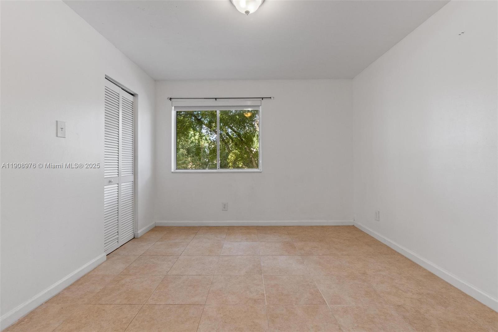 10421 Southwest 157th Place, Unit 206 Miami, FL 33196 - Photo 19 of 35 an empty room with windows
