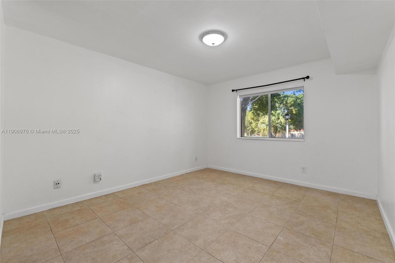 10421 Southwest 157th Place, Unit 206 Miami, FL 33196 - Photo 24 of 35 an empty room with windows