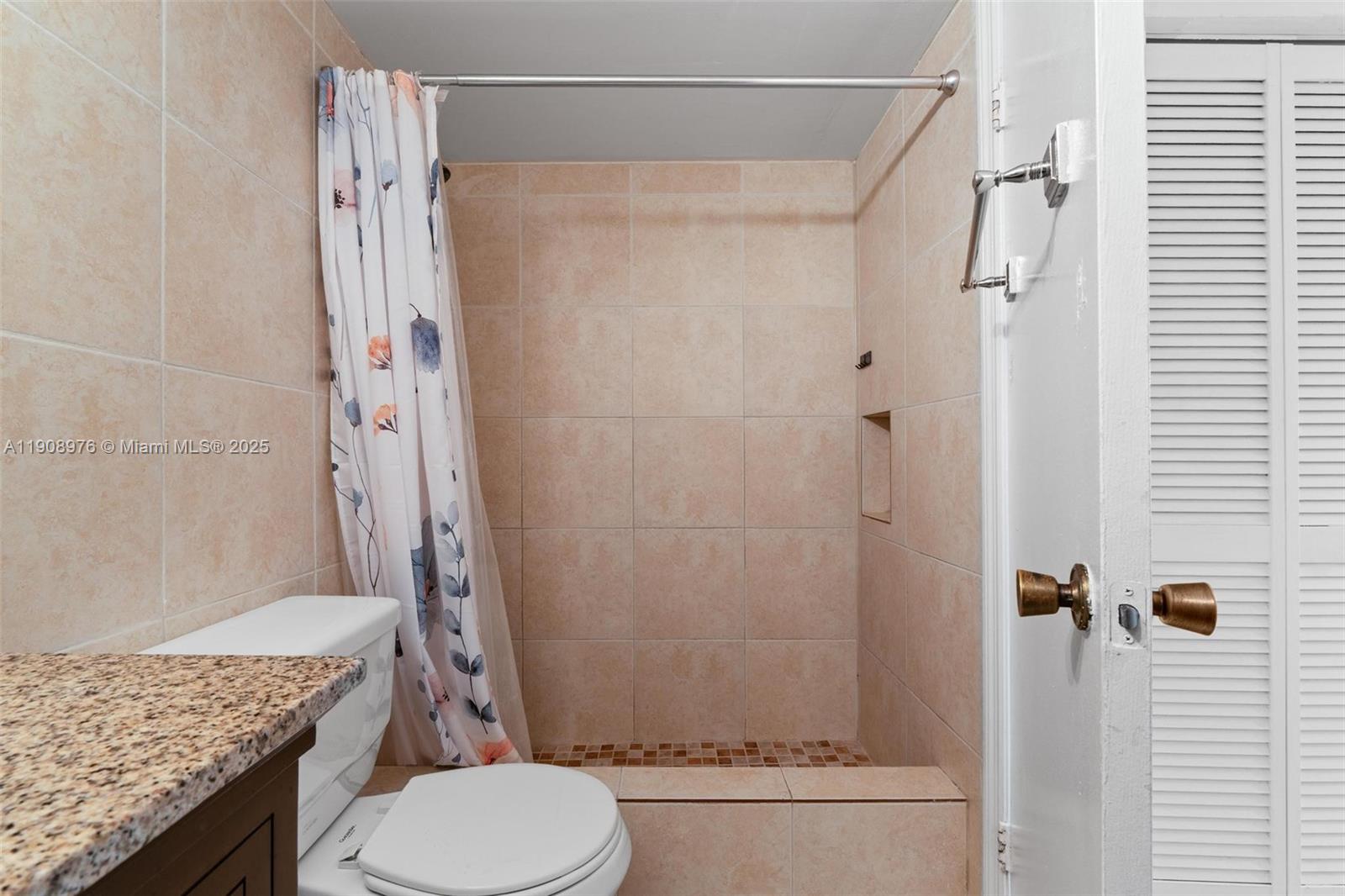 10421 Southwest 157th Place, Unit 206 Miami, FL 33196 - Photo 26 of 35 a bathroom with a granite countertop bathtub shower sink vanity and toilet