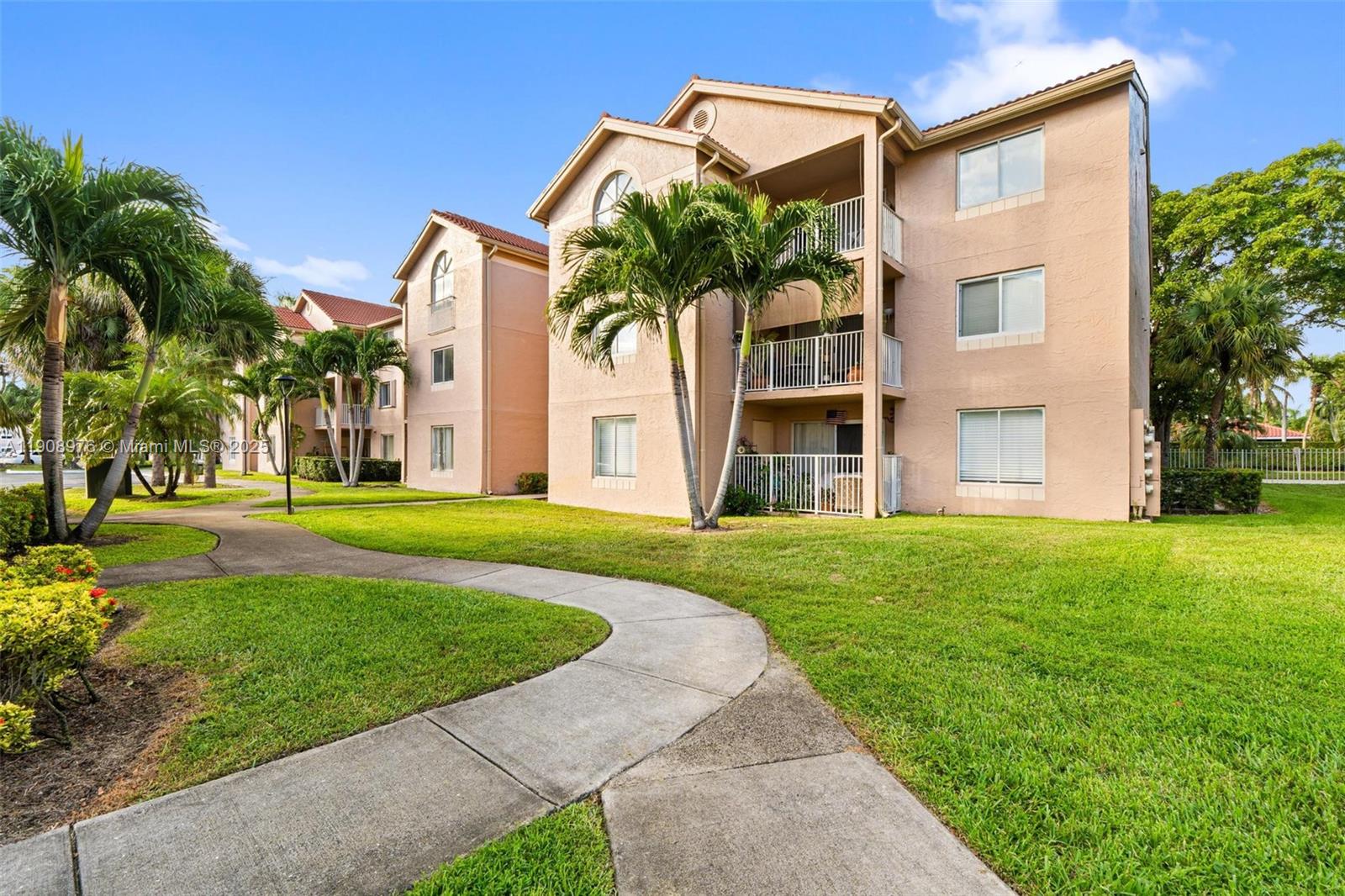 10421 Southwest 157th Place, Unit 206 Miami, FL 33196 - Photo 3 of 35 front view of a house with a yard