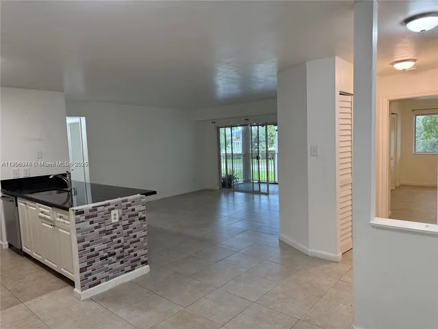 a kitchen with stainless steel appliances granite countertop a stove and a sink