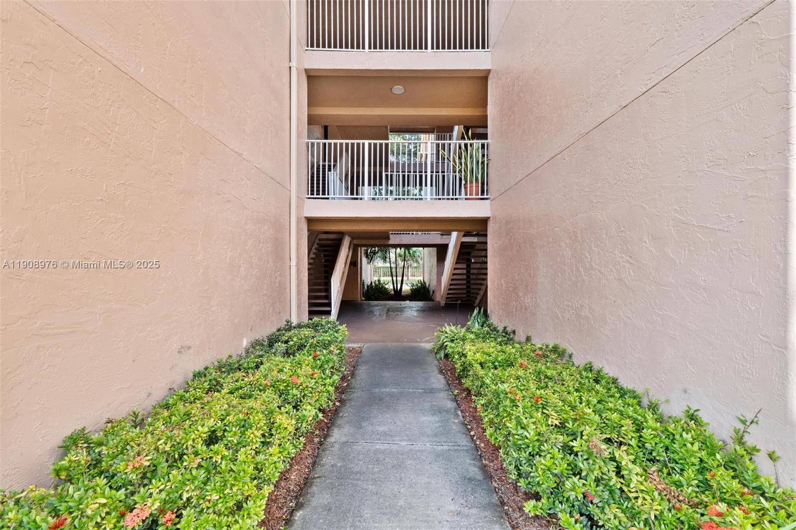 10421 Southwest 157th Place, Unit 206 Miami, FL 33196 - Photo 4 of 35 front view of front door of house with green space