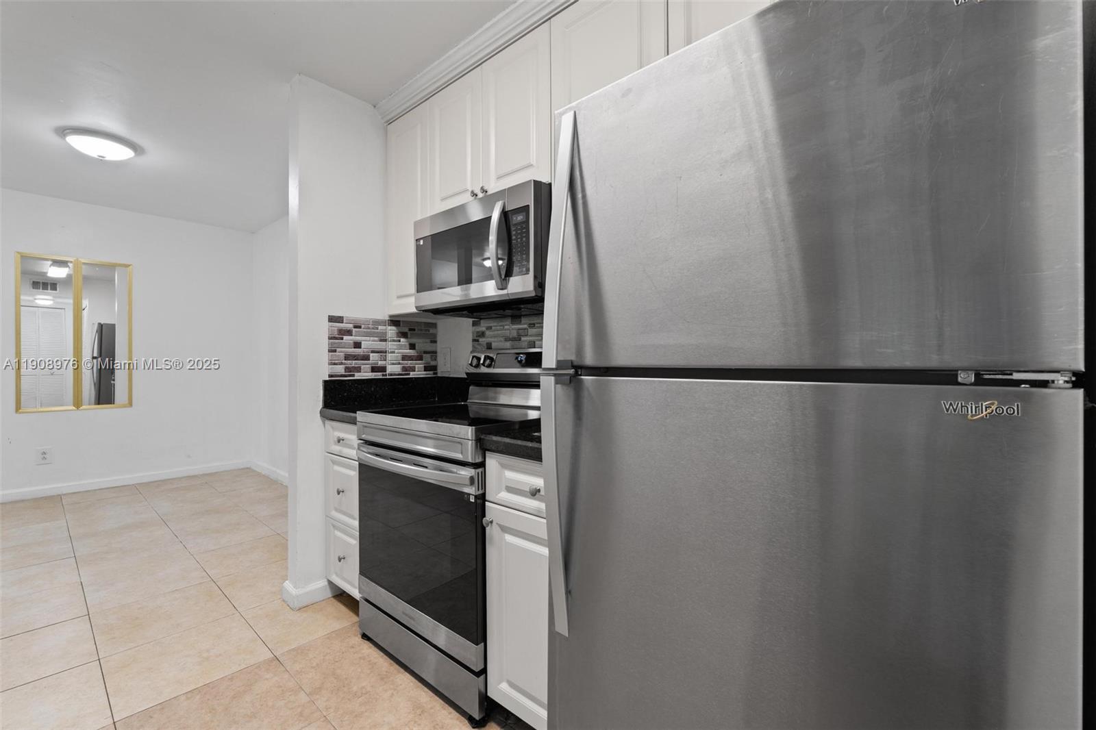 10421 Southwest 157th Place, Unit 206 Miami, FL 33196 - Photo 10 of 35 a kitchen with stainless steel appliances a refrigerator and a stove