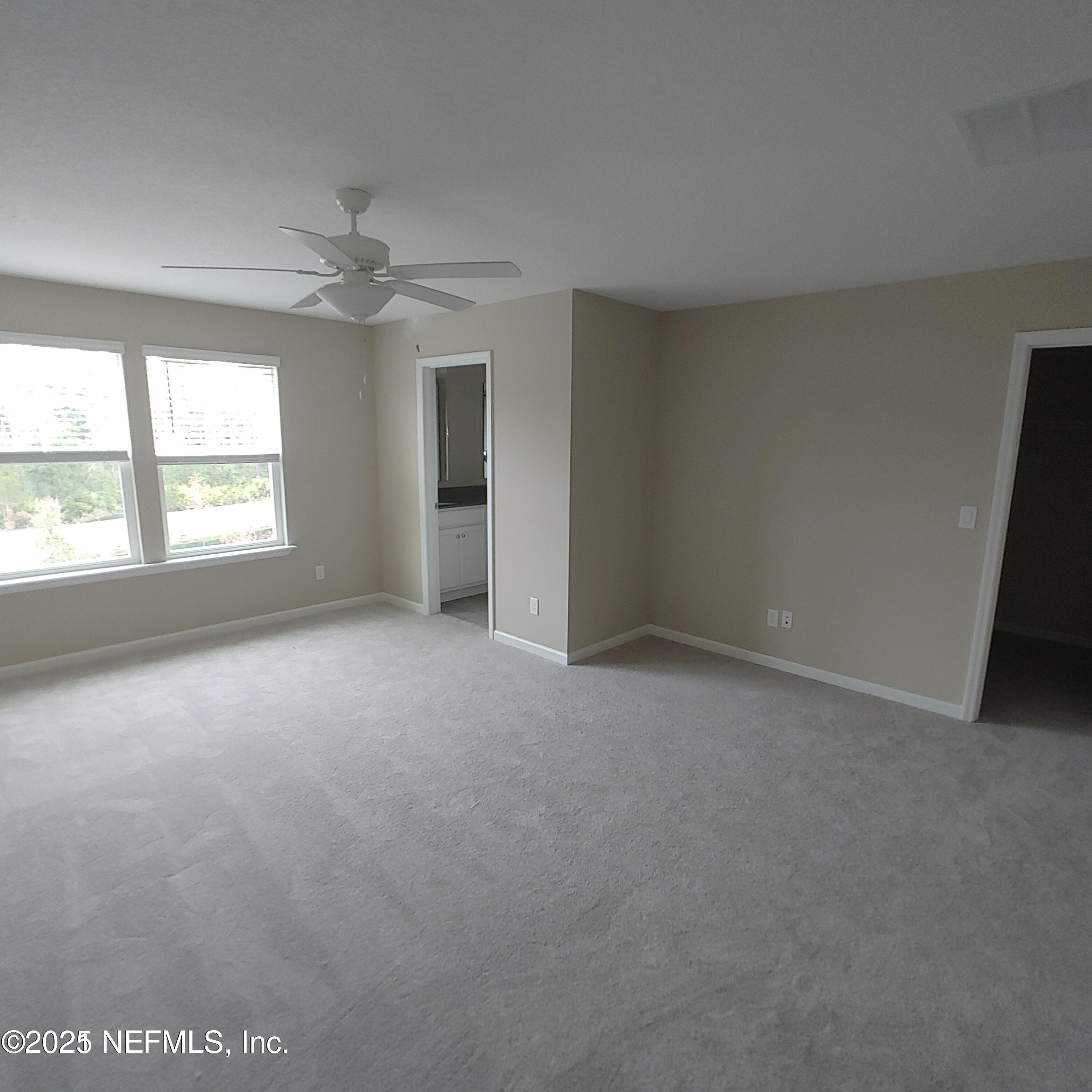 98 Boracay Circle St. Johns, FL 32259 - Photo 17 of 22 an empty room with a ceiling fan and windows