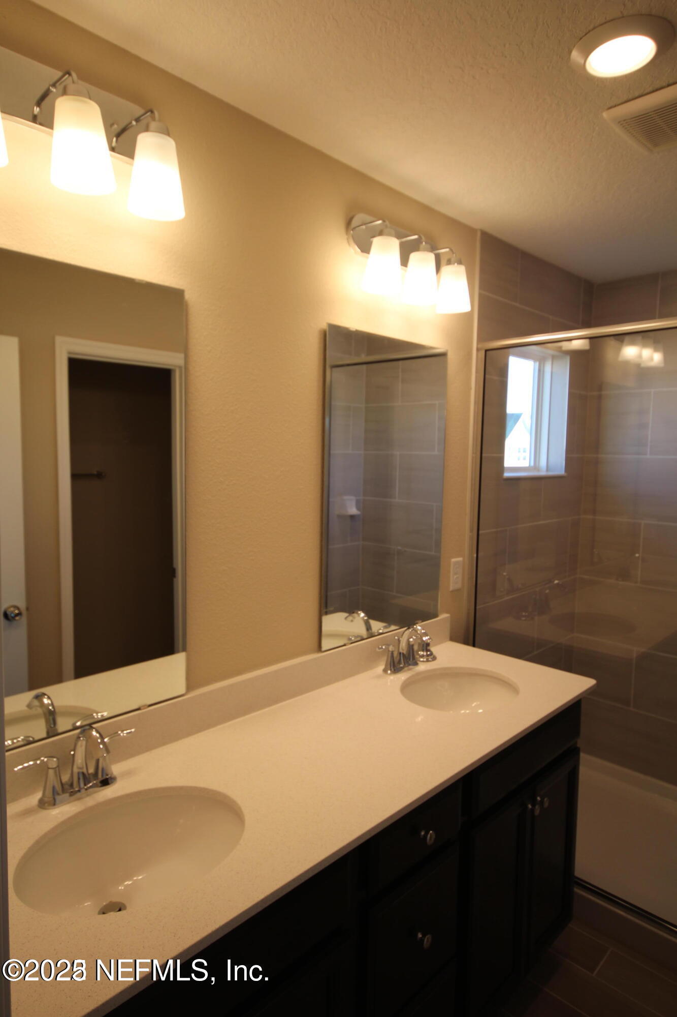 98 Boracay Circle St. Johns, FL 32259 - Photo 20 of 22 a bathroom with a sink vanity and a mirror