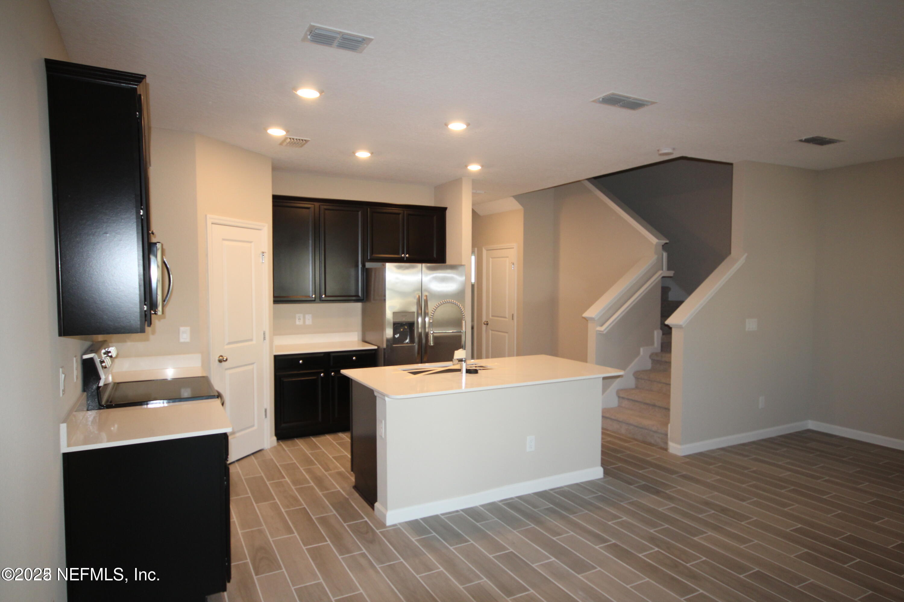 98 Boracay Circle St. Johns, FL 32259 - Photo 8 of 22 a room with kitchen island a sink wooden floor and utility