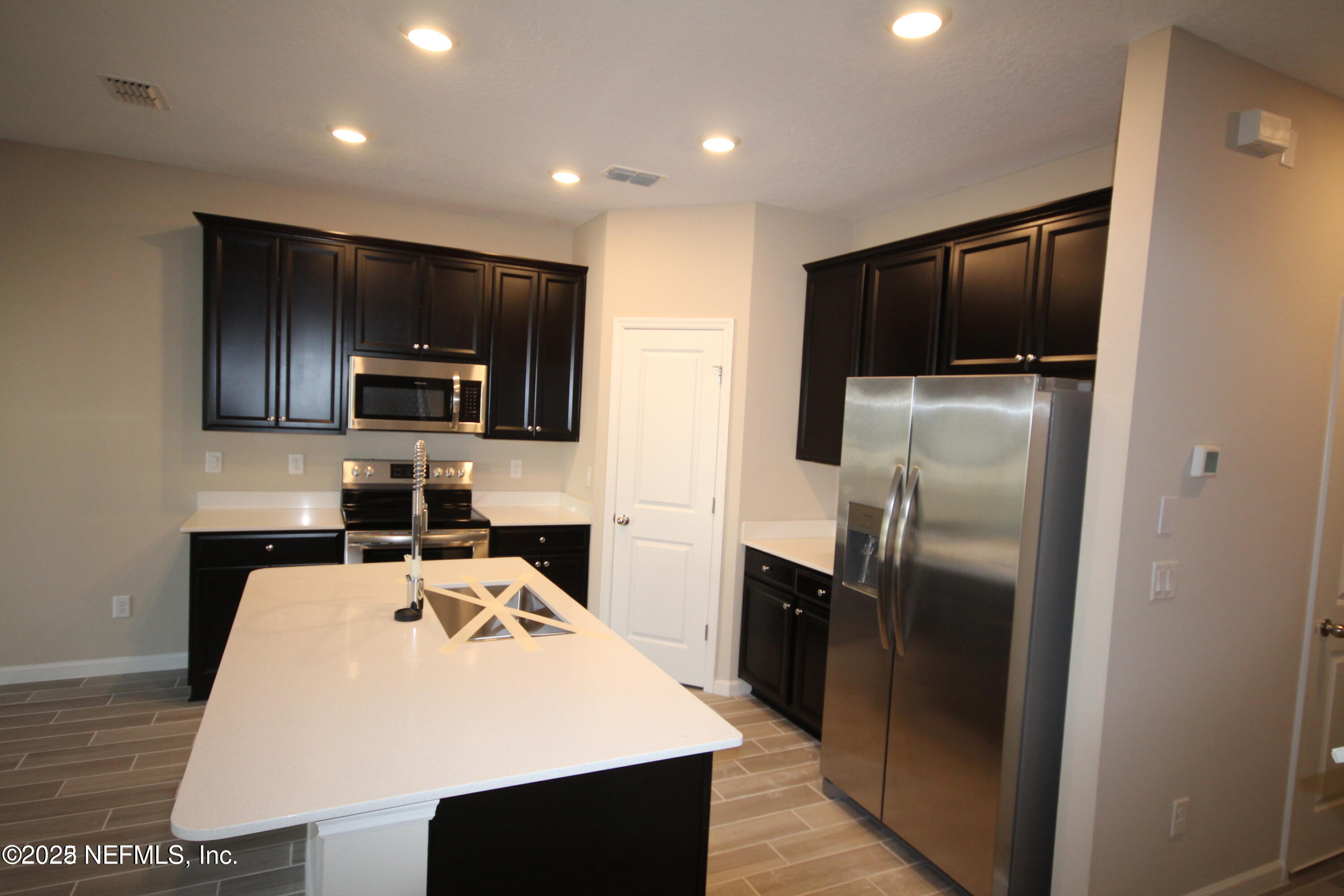 98 Boracay Circle St. Johns, FL 32259 - Photo 10 of 22 a kitchen that has a refrigerator a stove a microwave and a sink