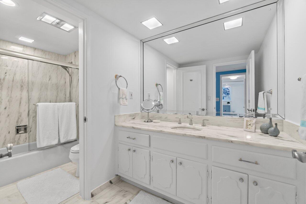 700 South Ocean Boulevard, Unit 405 Boca Raton, FL 33432 - Photo 23 of 59 a bathroom with a double vanity sink mirror double and shower