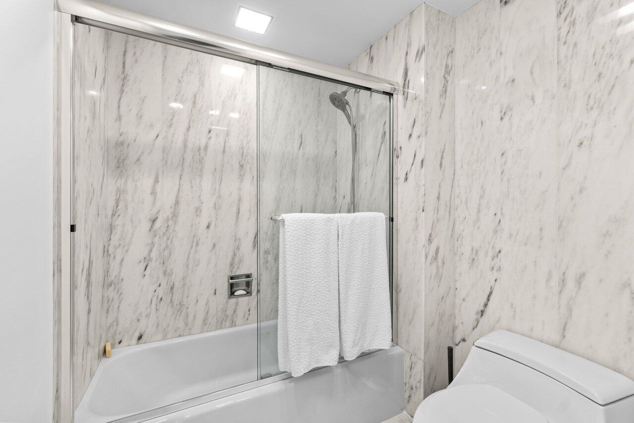 700 South Ocean Boulevard, Unit 405 Boca Raton, FL 33432 - Photo 24 of 59 a bathroom with a shower and a tub