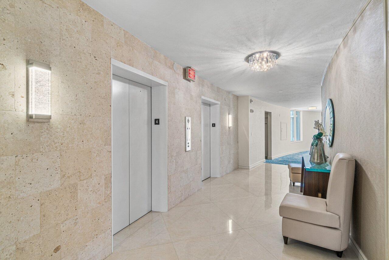 700 South Ocean Boulevard, Unit 405 Boca Raton, FL 33432 - Photo 54 of 59 a living room with furniture and a chandelier