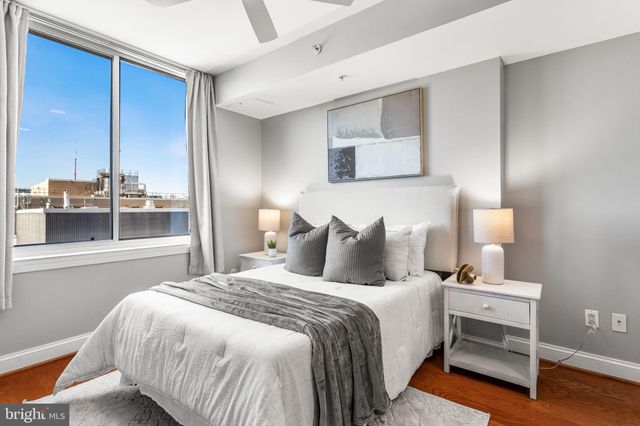 a bedroom with bed and wooden floor