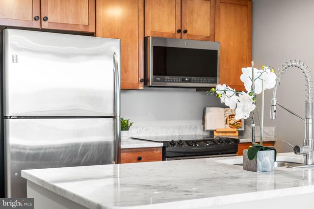 a kitchen with a sink a counter top space and cabinets