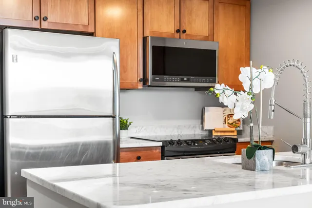 a kitchen with a sink a counter top space and cabinets