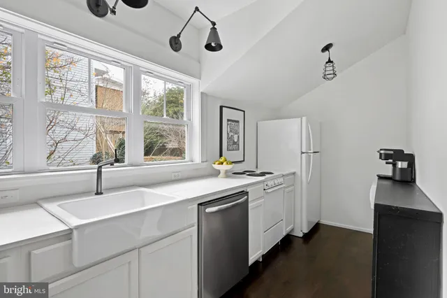 a kitchen with stainless steel appliances granite countertop a sink and a stove