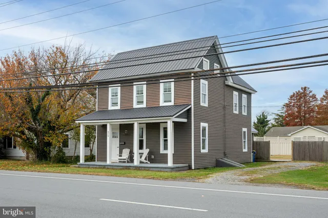 a view of a house with a swimming pool and a yard
