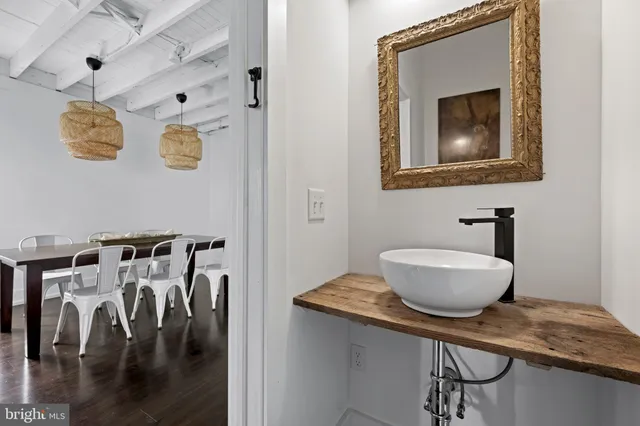 a bathroom with a granite countertop sink a mirror and vanity