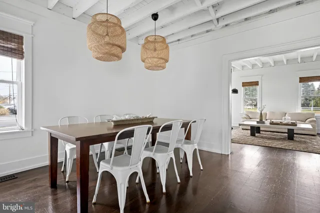 a view of a dining room with furniture wooden floor and chandelier