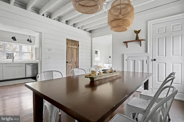 a living room with kitchen island furniture and a chandelier