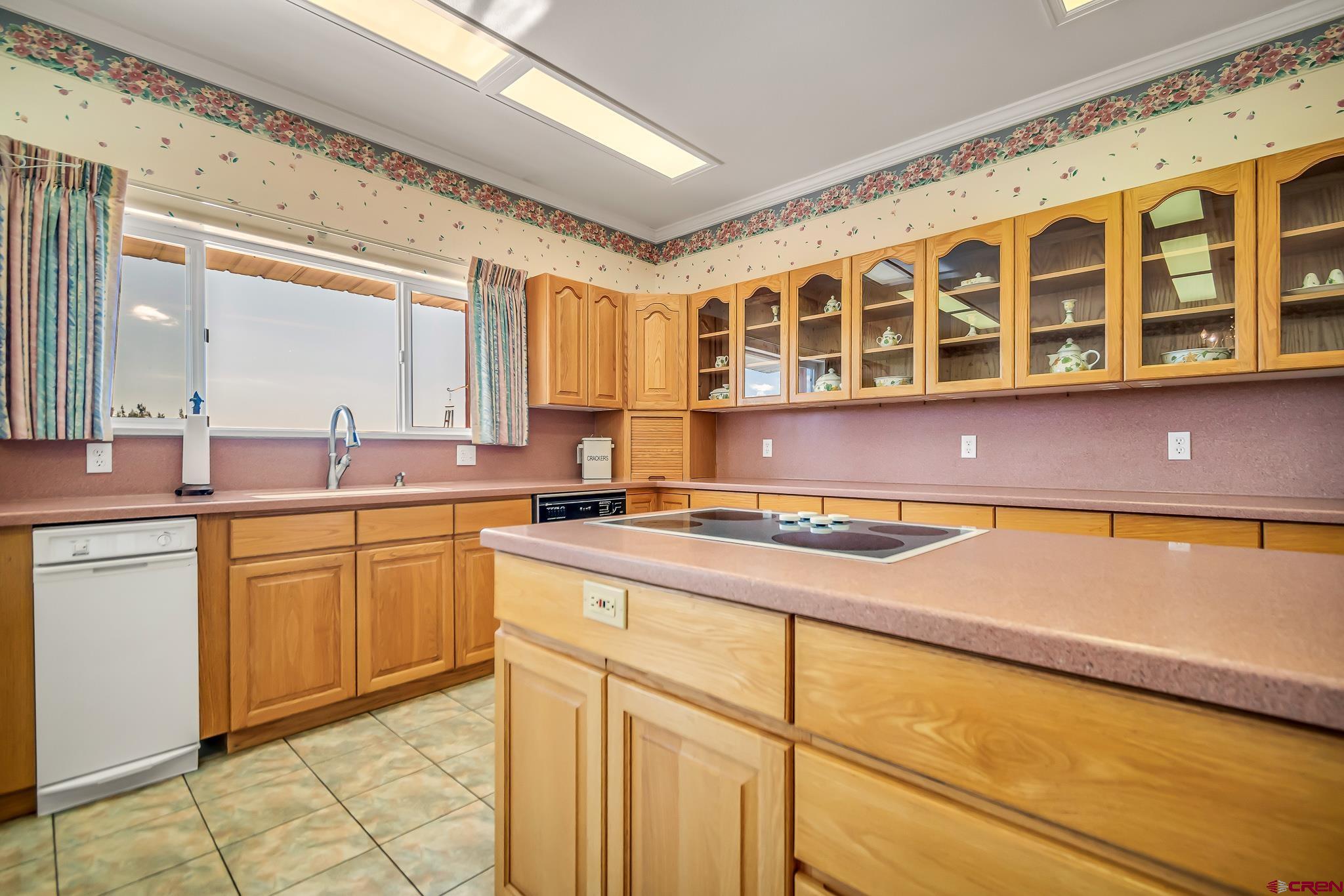 24344 Ute Trail Road Cedaredge, CO 81413 - Photo 13 of 33 a kitchen with a sink stove and cabinets