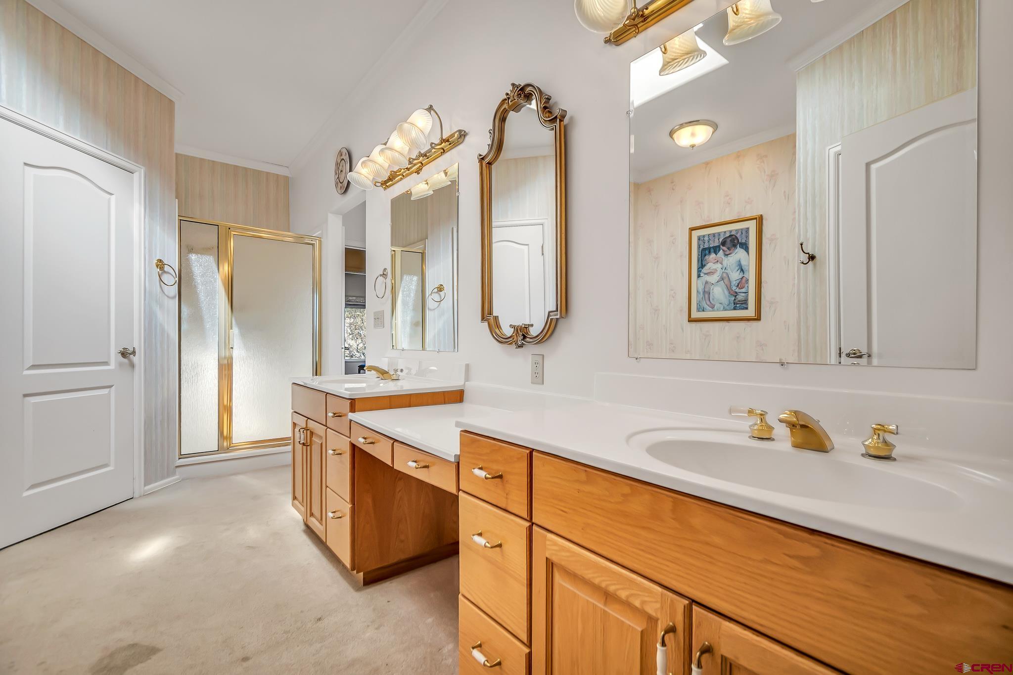 24344 Ute Trail Road Cedaredge, CO 81413 - Photo 24 of 33 a spacious bathroom with a sink double vanity granite and a mirror