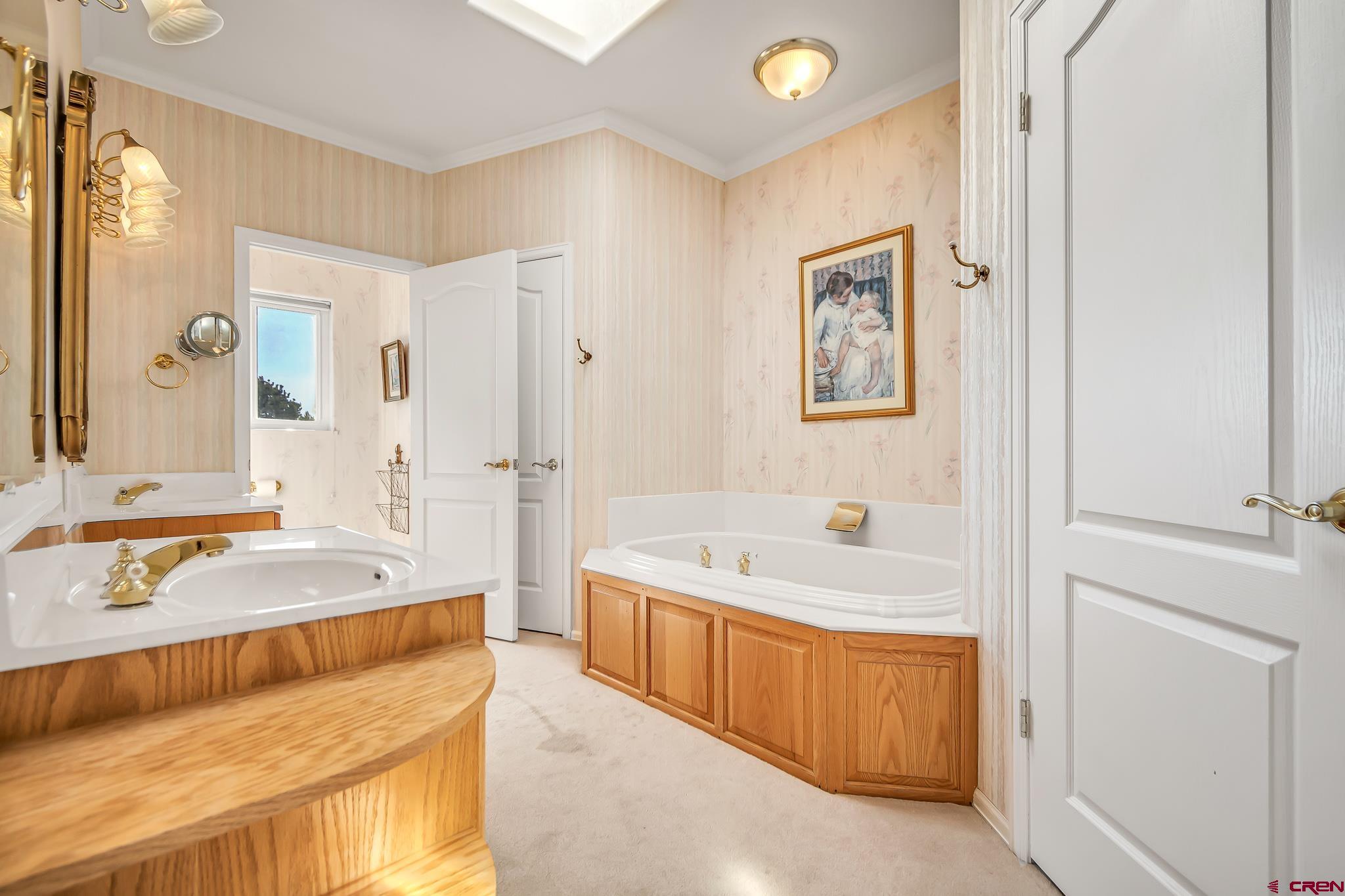 24344 Ute Trail Road Cedaredge, CO 81413 - Photo 25 of 33 a spacious bathroom with a tub sink and mirror