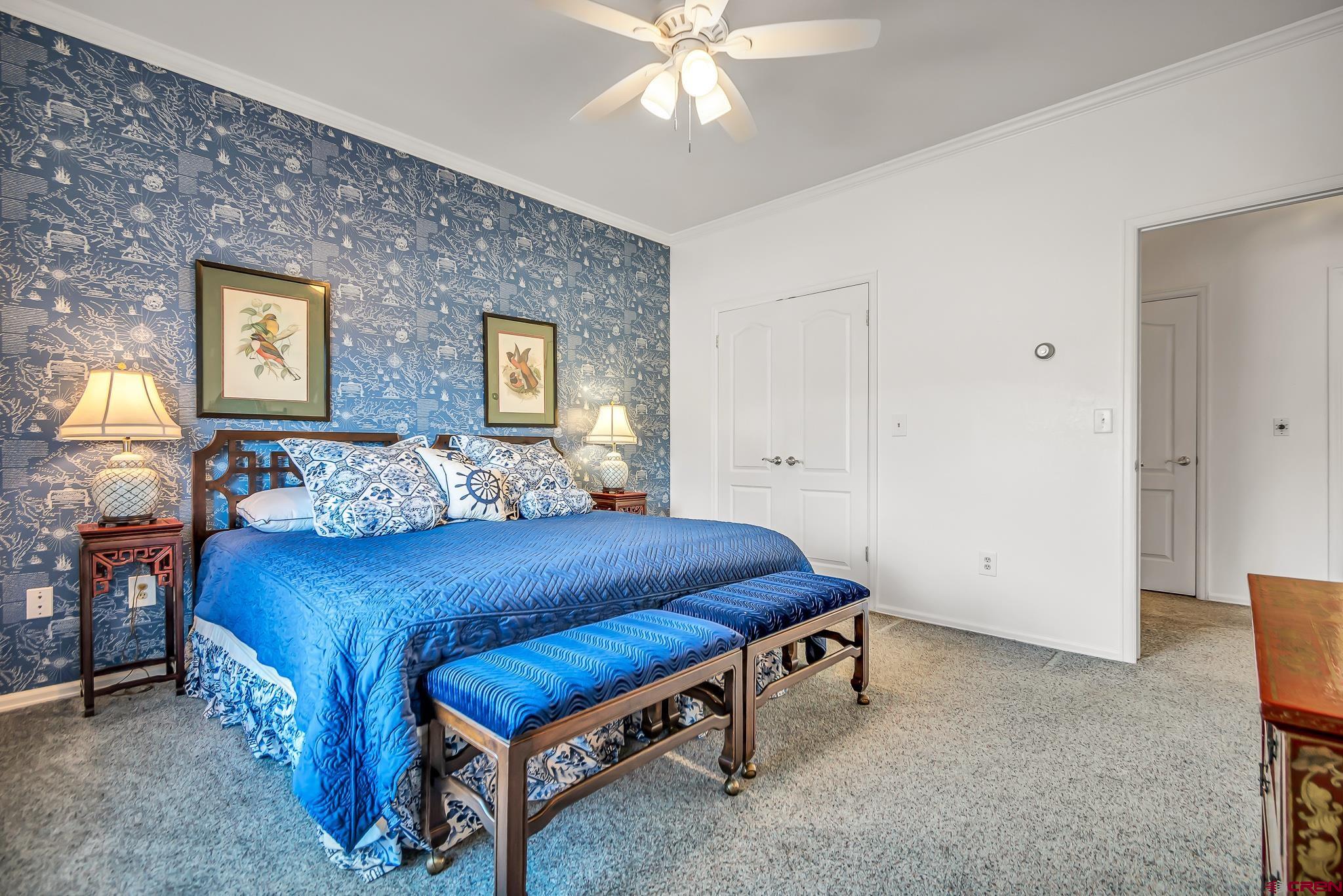 24344 Ute Trail Road Cedaredge, CO 81413 - Photo 28 of 33 a bedroom with a bed and a chandelier