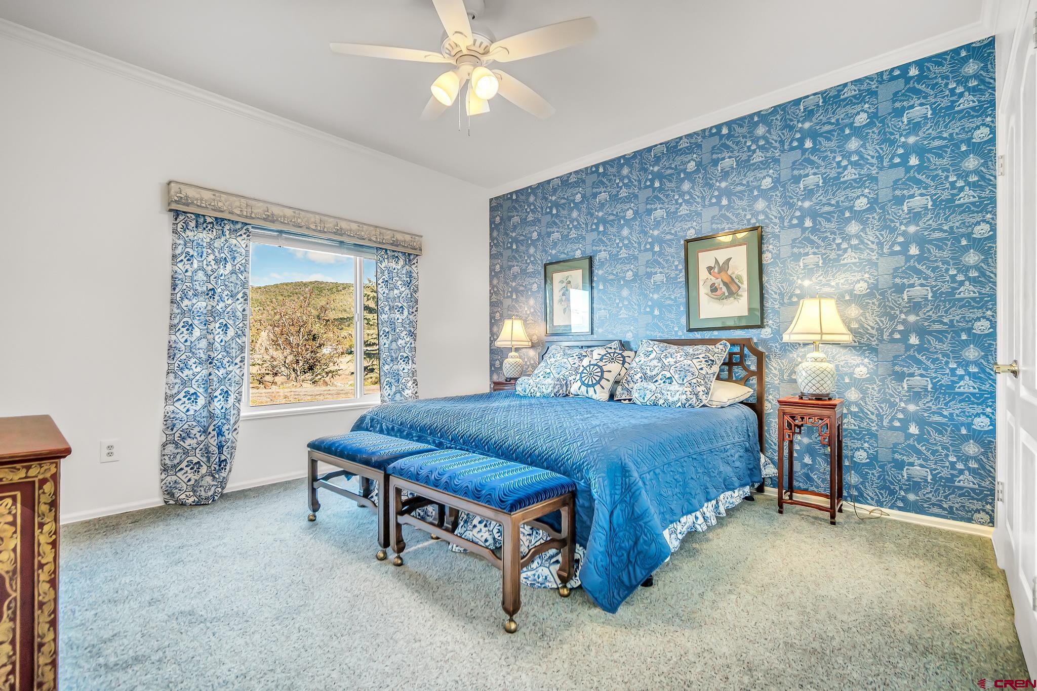 24344 Ute Trail Road Cedaredge, CO 81413 - Photo 29 of 33 a bedroom with a bed and a table