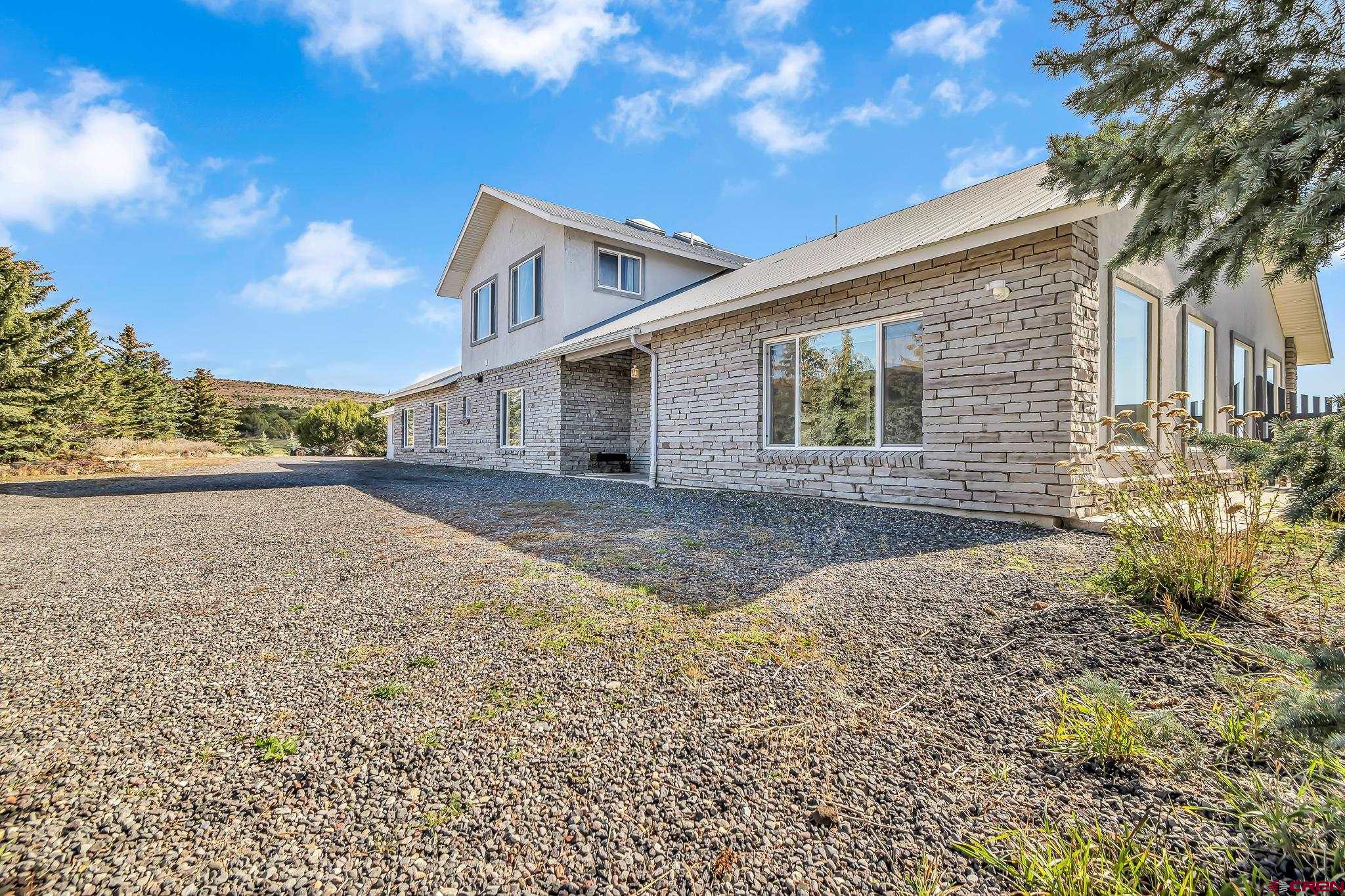 24344 Ute Trail Road Cedaredge, CO 81413 - Photo 10 of 33 a view of a house with a yard