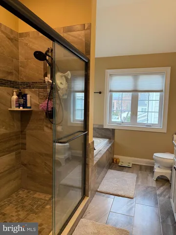 a bathroom with a tub and a shower
