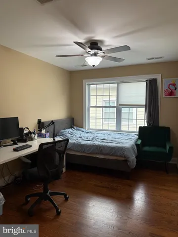 a bedroom with a bed and a desk