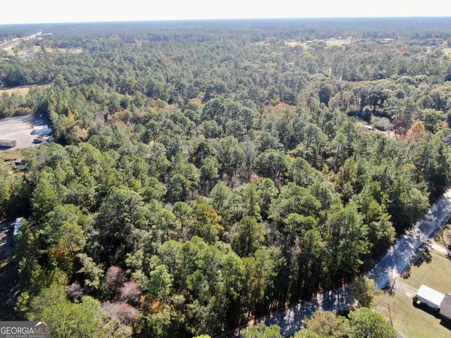 an aerial view of a houses with a yard