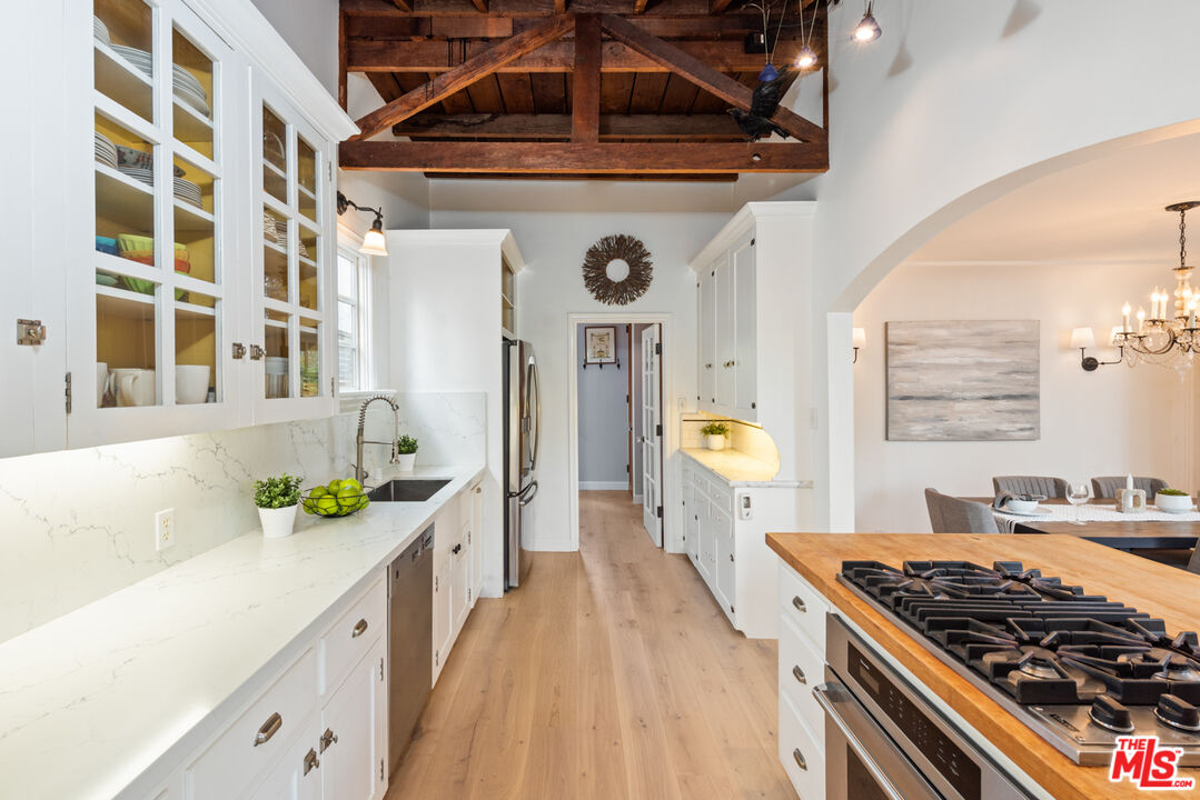 723 Crestmoore Place Venice, CA 90291 - Photo 11 of 33 a kitchen with stainless steel appliances granite countertop a stove and a sink
