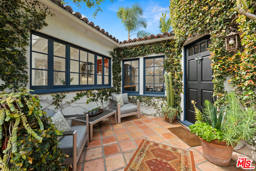 723 Crestmoore Place Venice, CA 90291 - Photo 2 of 33 a view of a patio with table and chairs potted plants with wooden fence