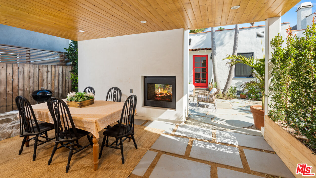 723 Crestmoore Place Venice, CA 90291 - Photo 21 of 33 a view of a patio with table and chairs potted plants with wooden floor