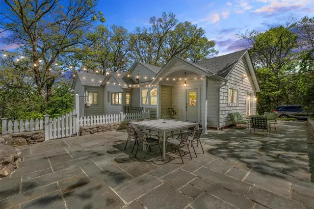 a backyard of a house with table and chairs