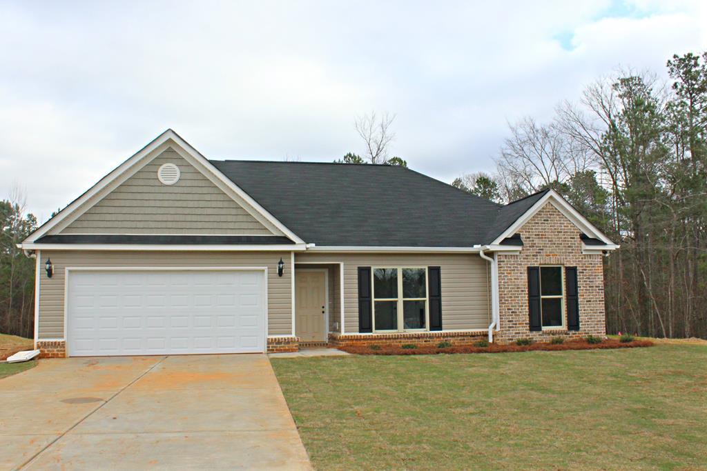 821 Weldon Road Forsyth, GA 31029 - Photo 1 of 8 front view of a house with a garden