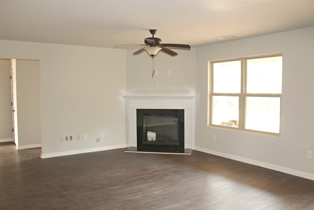 821 Weldon Road Forsyth, GA 31029 - Photo 2 of 8 an empty room with windows and a fireplace