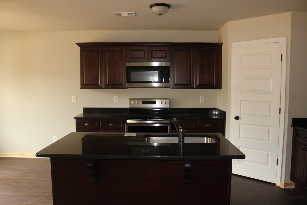 821 Weldon Road Forsyth, GA 31029 - Photo 3 of 8 a kitchen with a sink and cabinets