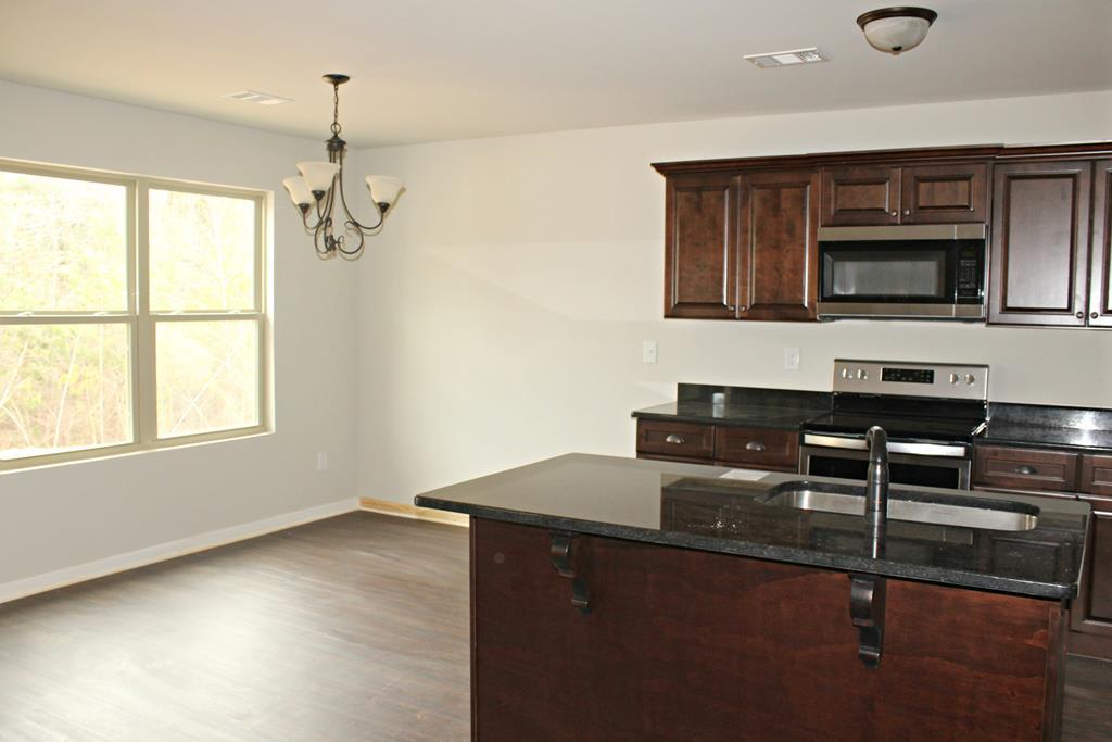 821 Weldon Road Forsyth, GA 31029 - Photo 4 of 8 a kitchen with stainless steel appliances granite countertop a sink and a microwave