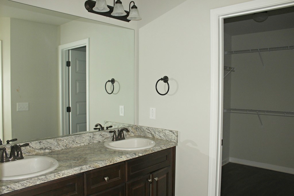821 Weldon Road Forsyth, GA 31029 - Photo 6 of 8 a bathroom with a granite countertop sink and a mirror