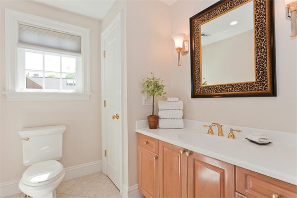 23 Slocum Road Lexington, MA 02421 - Photo 20 of 30 a bathroom with a toilet a sink a vanity and mirror