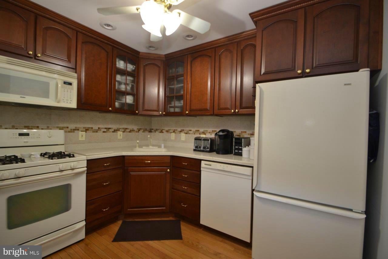 311 Bryanstone Road Reisterstown, MD 21136 - Photo 14 of 23 a kitchen with granite countertop stainless steel appliances and wooden cabinets