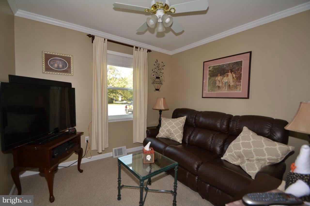 311 Bryanstone Road Reisterstown, MD 21136 - Photo 17 of 23 a living room with furniture and a flat screen tv