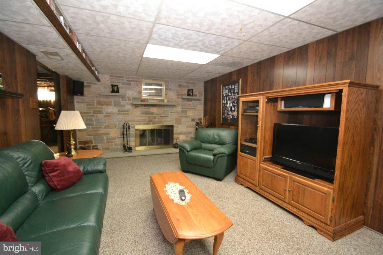 311 Bryanstone Road Reisterstown, MD 21136 - Photo 19 of 23 a living room with furniture a flat screen tv and a fireplace