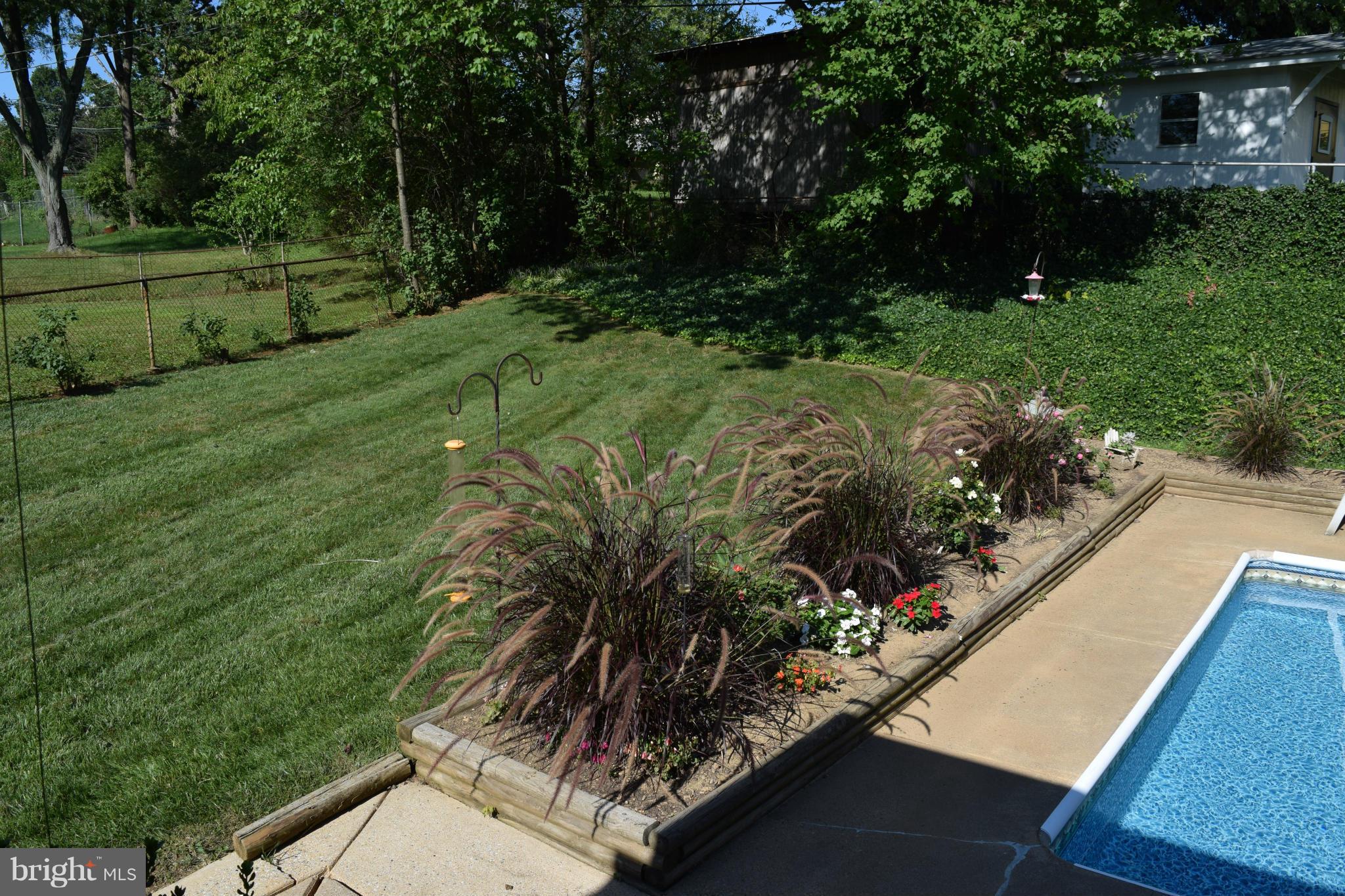 311 Bryanstone Road Reisterstown, MD 21136 - Photo 6 of 23 a view of a garden with a bench
