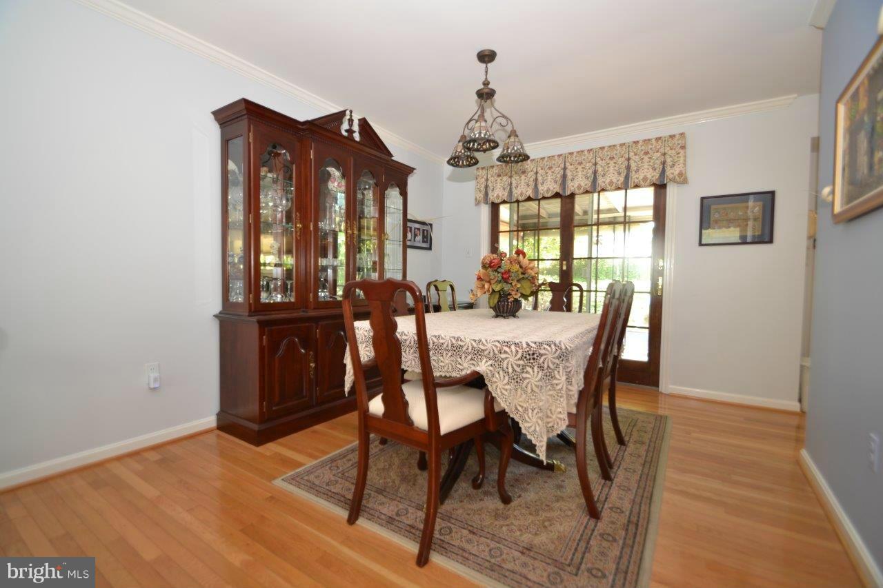 311 Bryanstone Road Reisterstown, MD 21136 - Photo 10 of 23 a view of a dining room with furniture window and wooden floor