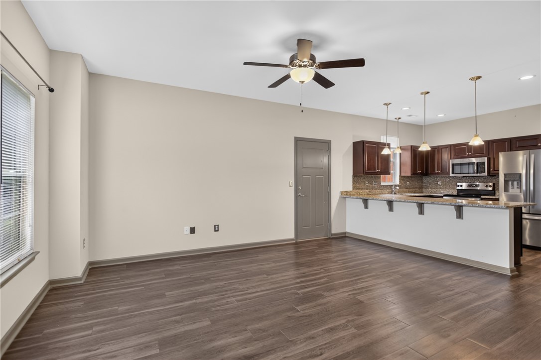 235 Pendleton Road, Unit K1 Clemson, SC 29631 - Photo 10 of 49 An open-concept living space with a contemporary kitchen and durable wood-look flooring.