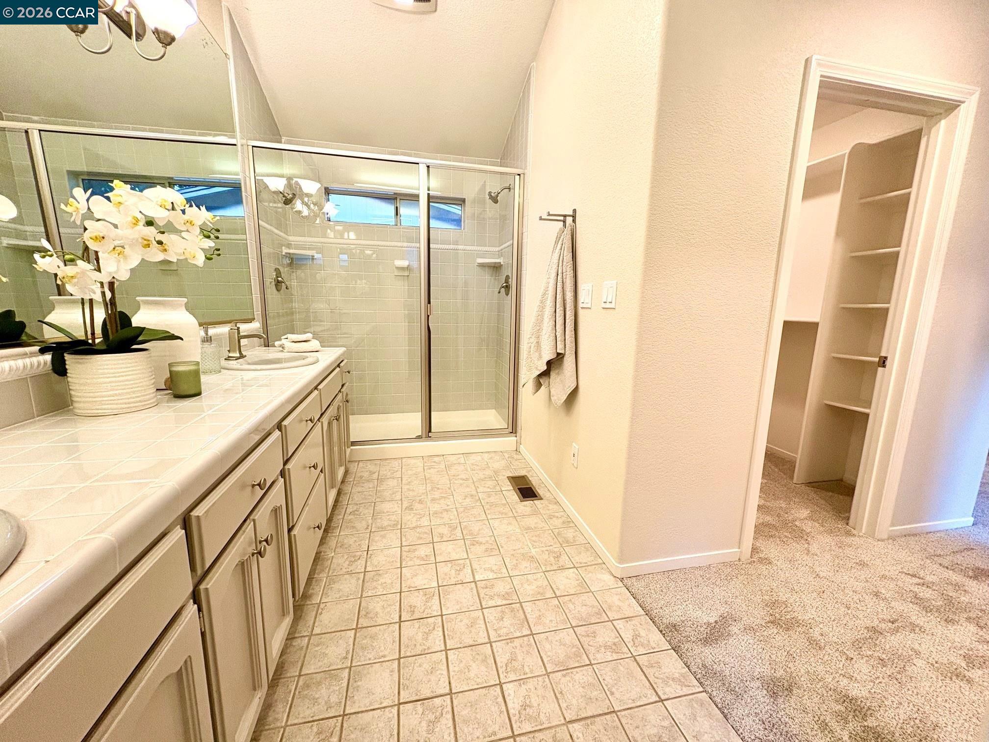 2589 Pebble Beach Loop Lafayette, CA 94549 - Photo 18 of 32 a bathroom with a granite countertop shower a sink and a bathtub